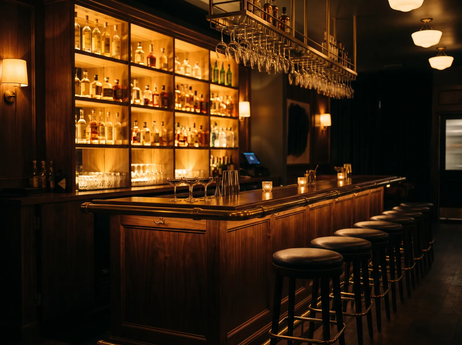 The bar, with a backlit shelf of pisco bottles